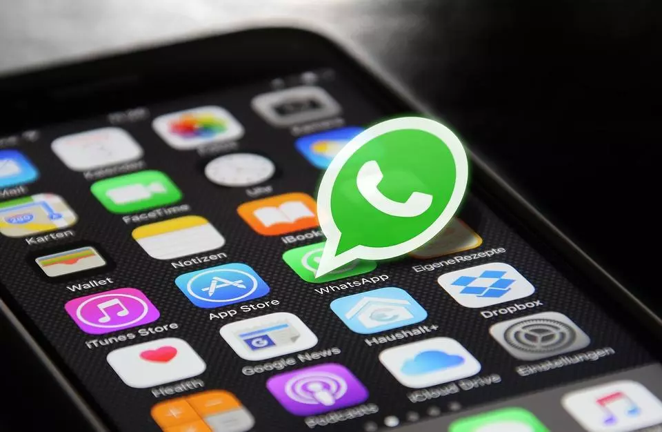 image of an Iphone with the whatsapp logo standing out 