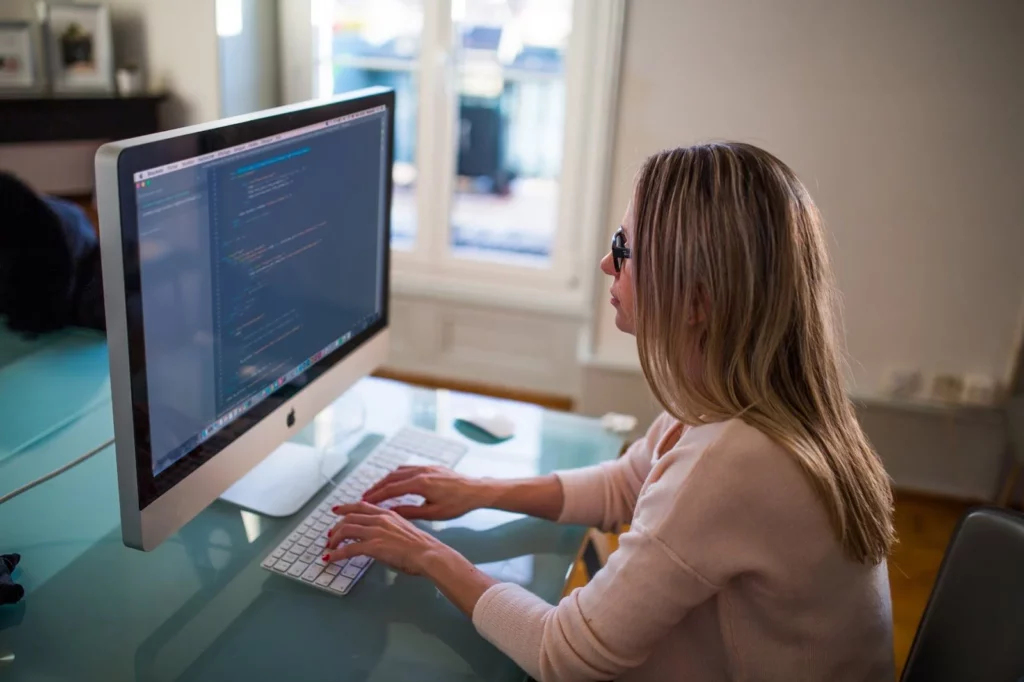 woman sitting at computer typing